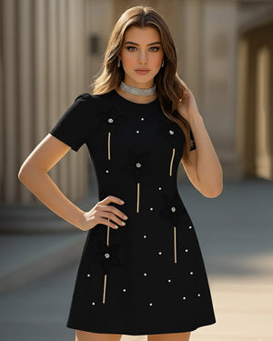 Woman wearing a black dress with white buttons in an outdoor setting