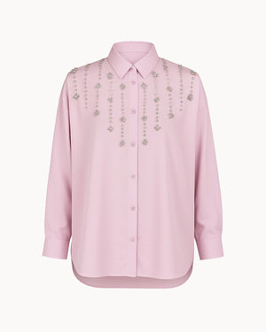 Pink shirt with decorative elements on a white background