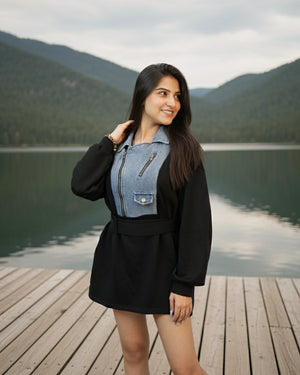 Woman standing on a wooden dock by a lake with mountains in the background