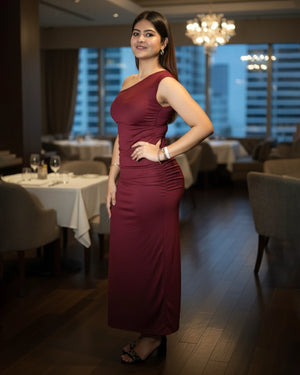 Woman in a burgundy dress standing in a restaurant setting