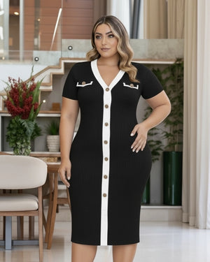 Woman wearing a black dress with white accents in a modern indoor setting