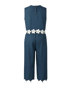 Blue jumpsuit with a white floral belt on a white background