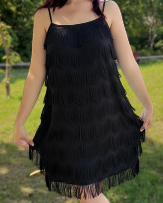Black fringe dress worn by a person in an outdoor setting