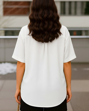 Person wearing a white shirt with a blurred background