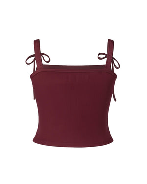 Maroon crop top with thin straps on a white background