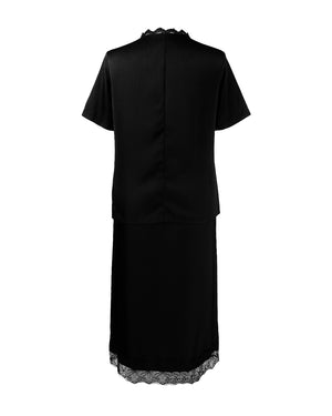 Black dress with lace trim on a white background