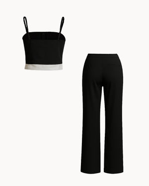 Black crop top and black pants on a white background