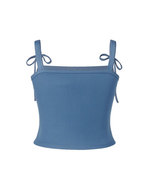 Blue crop top with thin straps on a white background