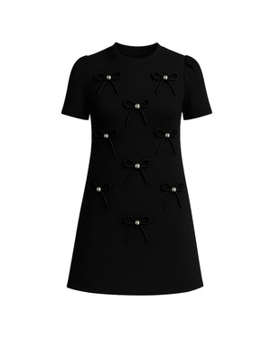 Black dress with bow details on a white background