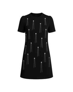 Black dress with silver embellishments on a white background