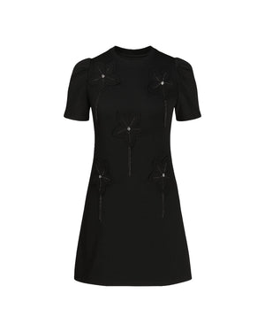 Black dress with decorative elements on a white background