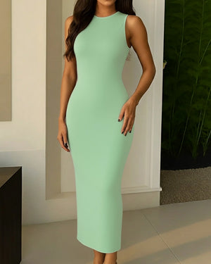 Woman wearing a light green dress indoors with a neutral background
