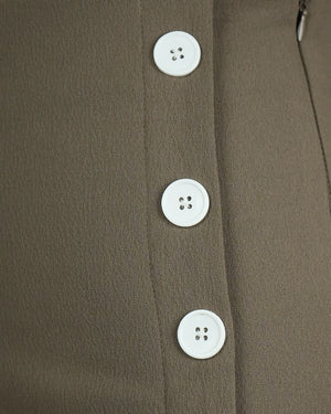 Close-up of a brown coat with white buttons