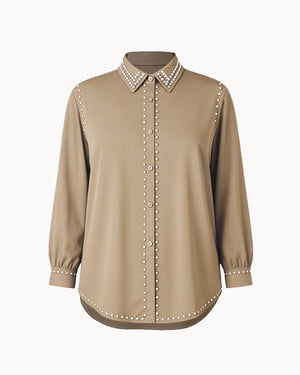 Beige blouse with pearl-studded collar and cuffs on a white background