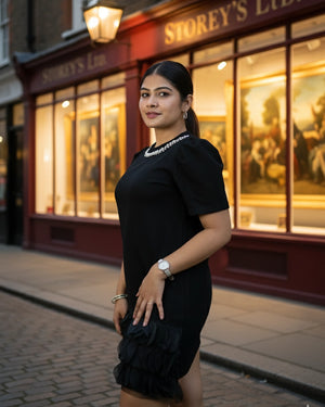 Woman in a black dress standing in front of Storey's Inn.