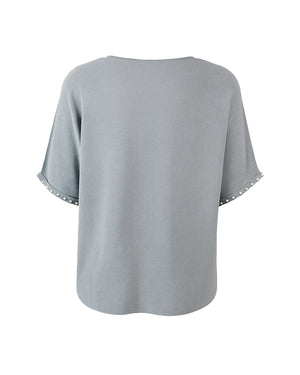 Gray blouse with lace trim on sleeves and hem against a white background