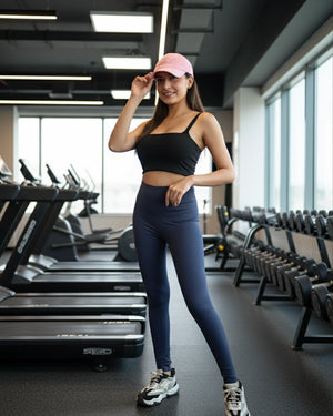 Woman in athletic wear posing in a gym