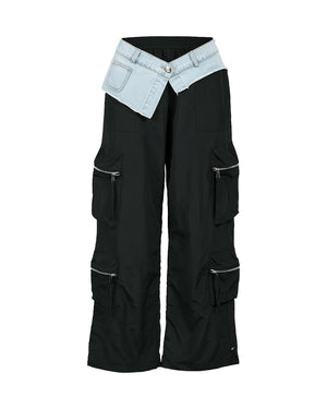 Black cargo pants with light blue denim patch on a white background