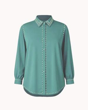 Teal blouse with decorative collar and cuffs on a white background