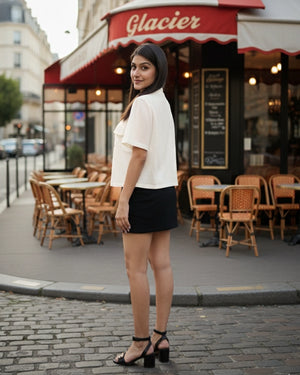 Woman standing in front of a café named 'Glacier' on a city street.