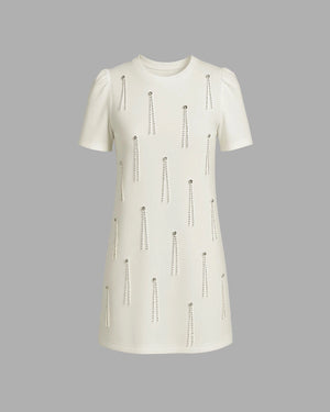 White dress with decorative elements on a gray background