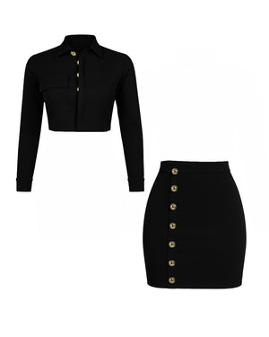Black long-sleeve crop top and black skirt with gold buttons on a white background