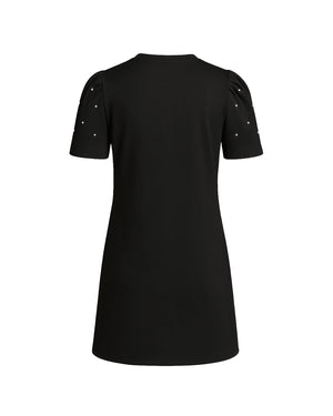 Black dress with embellishments on the shoulders against a white background