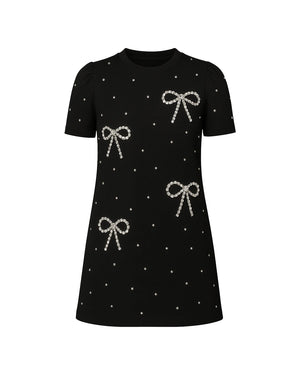 Black dress with silver bow patterns on a white background