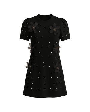 Black dress with floral embellishments on a white background