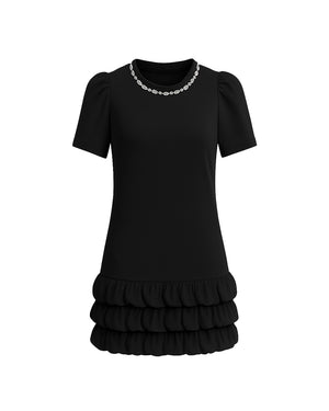 Black dress with ruffled skirt on a white background