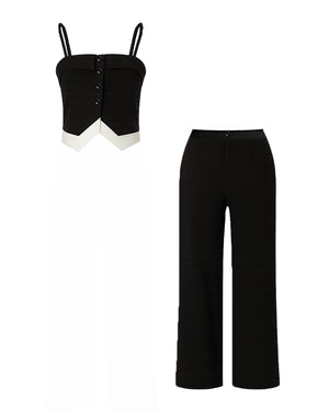 Black strapless top and black pants on a white background