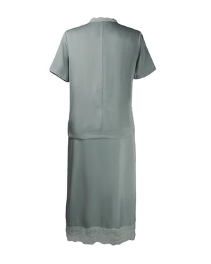 Green dress with lace hem on a white background