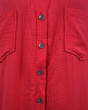 Close-up of a red textured shirt with buttons