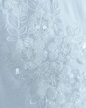 Floral lace pattern on a light blue background