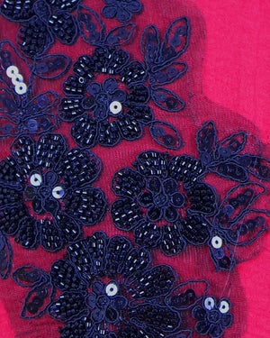 Navy blue floral embroidery with sequins on a red fabric background