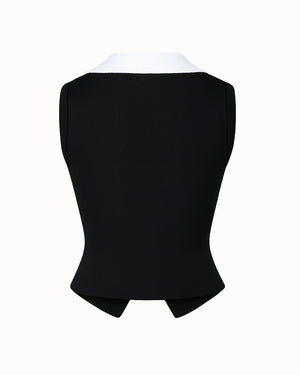 Black vest with white collar on a white background