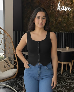 Woman wearing a black top and blue jeans in an indoor setting with 'have' branding.