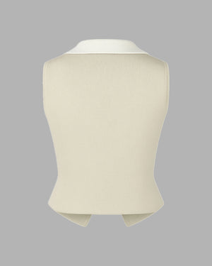 Beige knitted vest on a gray background