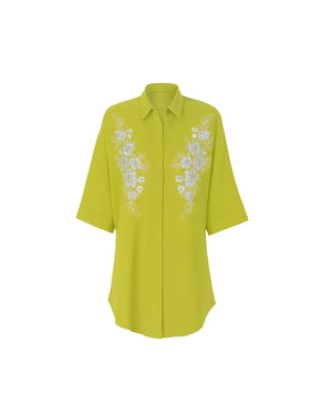 Yellow blouse with floral embroidery on a white background