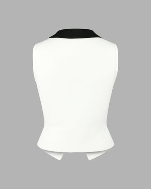 White sleeveless top with black collar on a gray background