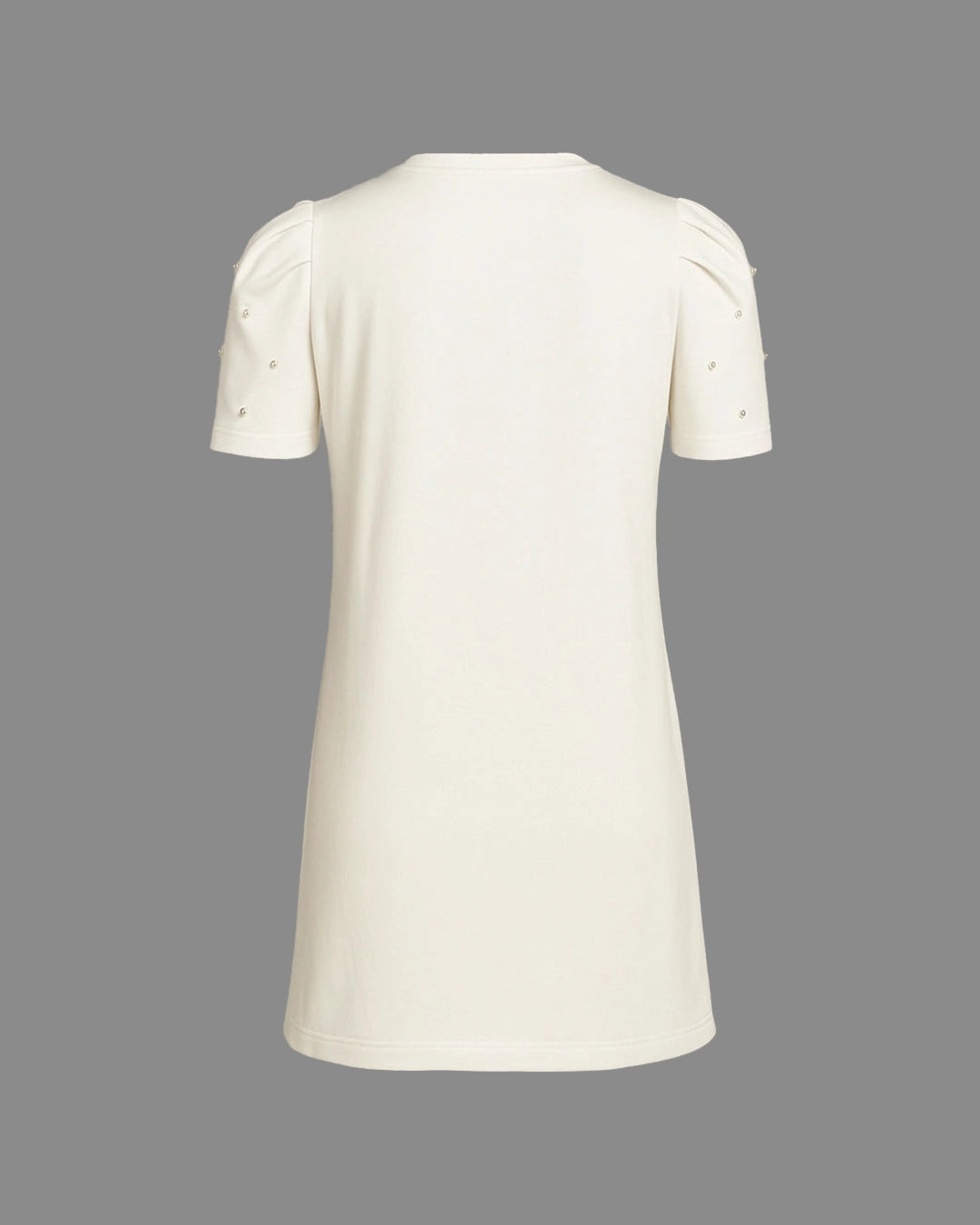 White dress with short sleeves and pearl embellishments on a gray background