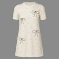 White dress with bow patterns on a gray background