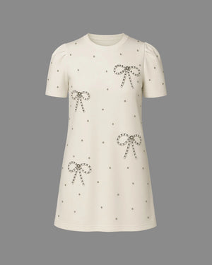 White dress with bow patterns on a gray background
