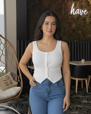 Woman wearing a white blouse and blue jeans standing in a modern cafe.
