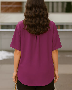 Person wearing a purple shirt with a blurred background