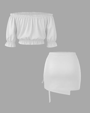 White off-shoulder top and skirt set on a gray background