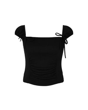 Black off-shoulder top with bow details on a white background