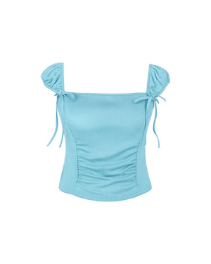 Light blue top with ruched design and tied sleeves on a white background