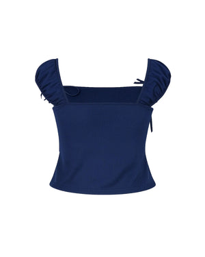 Navy blue top with ruffled shoulders on a white background