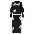 Black sweater and skirt set with white floral patterns on a white background